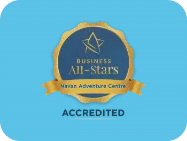 A gold-rimmed badge with a star and the words "Business All-Stars Heart Adventure Centre" on a blue background, celebrating Navan Adventure Centre. Below the badge is the word "ACCREDITED" in bold black letters.