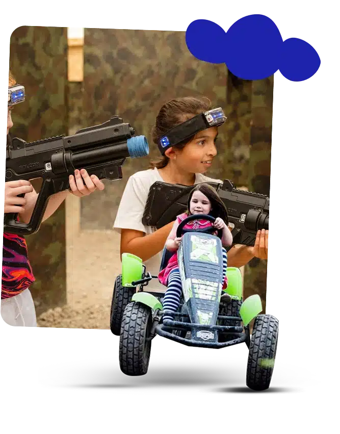Two children aiming laser tag guns in a camo-themed arena, both wearing headbands with sensors—perfect for Navan school adventure trips. In front, a younger child rides a green pedal go-kart, smiling, as blue cloud-like shapes appear in the top right corner.
